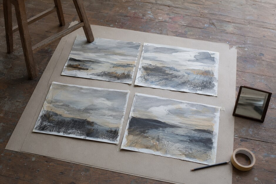 Four related landscape studies arranged on a studio floor for comparison and review.
